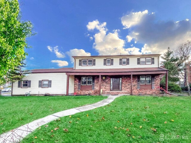 front of property featuring a front lawn and a porch