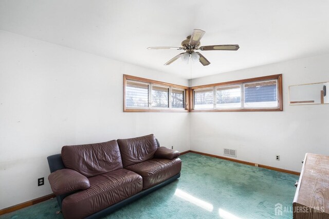 living room featuring carpet floors and ceiling fan