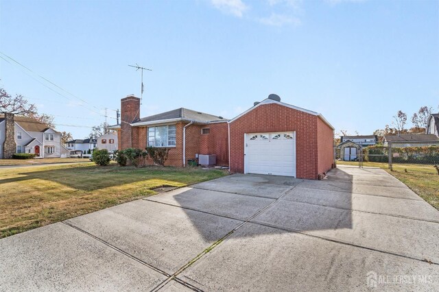 ranch-style home with a front lawn and central AC unit