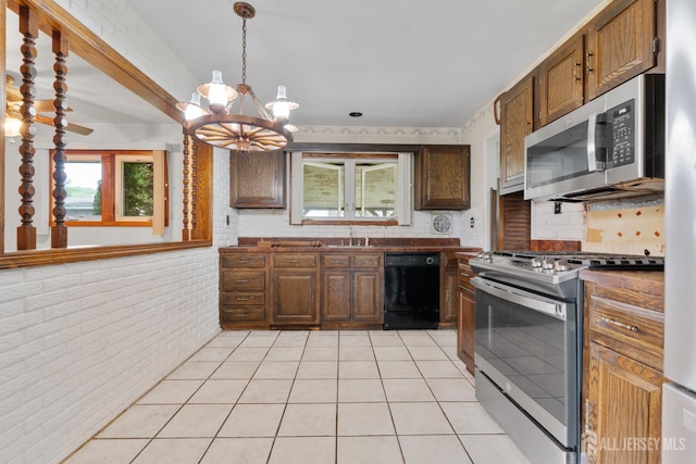 107 Athens Ave, Old Bridge, NJ 08879 - kitchen with stainless steel appliances, a chandelier, light tile patterned floors, backsplash, and dark countertops