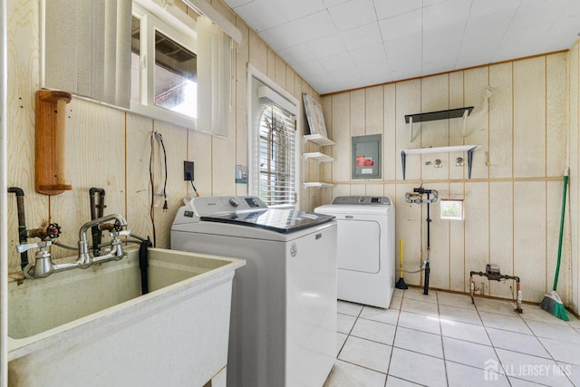 107 Athens Ave, Old Bridge, NJ 08879 - laundry room featuring separate washer and dryer, wooden walls, and light tile patterned flooring
