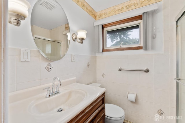 107 Athens Ave, Old Bridge, NJ 08879 - full bathroom featuring tile walls, vanity, toilet, and a shower with door