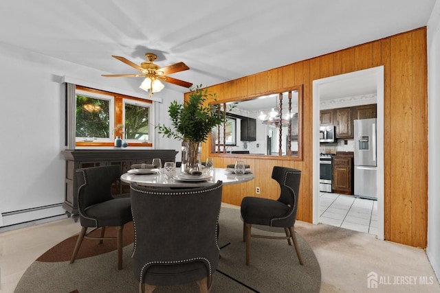 107 Athens Ave, Old Bridge, NJ 08879 - dining space with wooden walls, ceiling fan, a baseboard heating unit, a chandelier, and light carpet