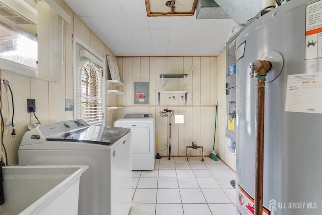 107 Athens Ave, Old Bridge, NJ 08879 - laundry room with gas water heater, washing machine and dryer, wooden walls, light tile patterned floors, and electric panel