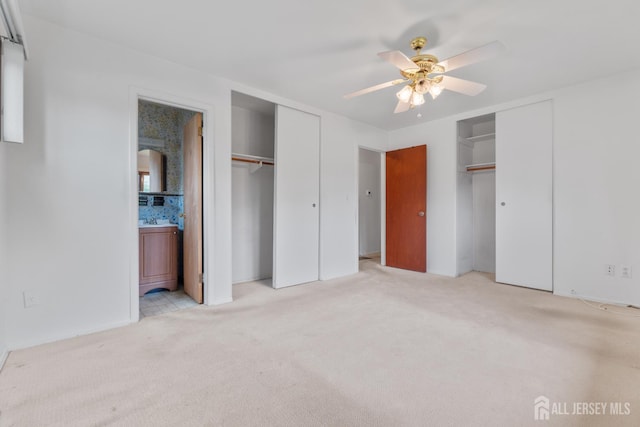107 Athens Ave, Old Bridge, NJ 08879 - unfurnished bedroom featuring multiple closets, light colored carpet, connected bathroom, and ceiling fan