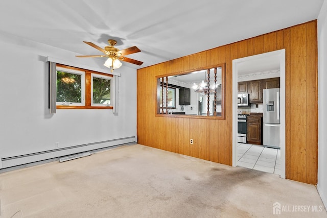 107 Athens Ave, Old Bridge, NJ 08879 - empty room featuring wood walls, light carpet, a baseboard heating unit, a ceiling fan, and a chandelier