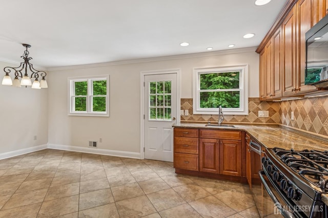 13 Spyros Dr, Old Bridge, NJ 08879 - kitchen with black microwave, dark stone countertops, plenty of natural light, brown cabinets, and crown molding