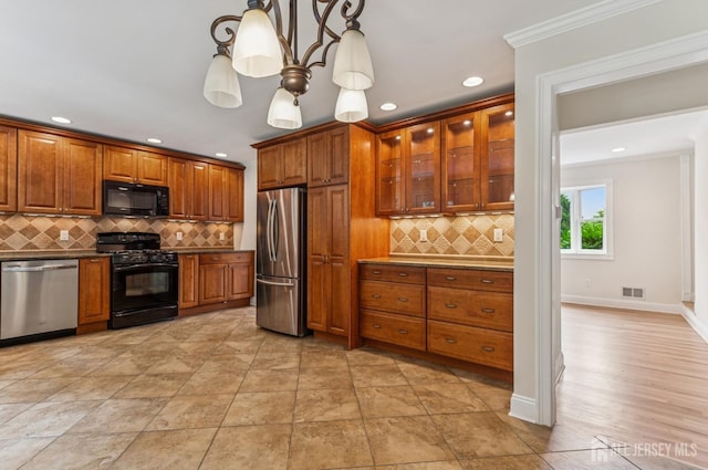 13 Spyros Dr, Old Bridge, NJ 08879 - kitchen featuring black appliances, brown cabinets, backsplash, glass insert cabinets, and hanging light fixtures