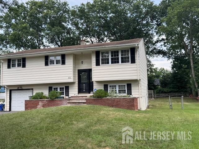 451 Hillside Ave, Piscataway, NJ 08854 - raised ranch featuring a garage, a chimney, and driveway
