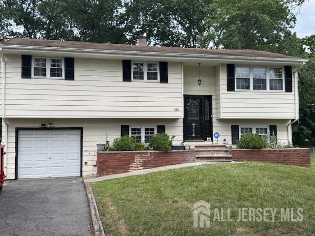 451 Hillside Ave, Piscataway, NJ 08854 - split foyer home featuring a front lawn, an attached garage, a chimney, and driveway