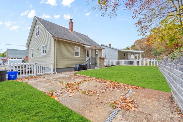 rear view of property with a lawn