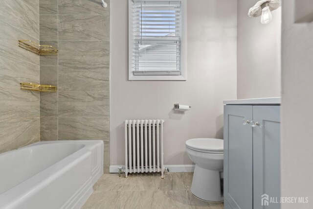 bathroom featuring vanity, toilet, and radiator