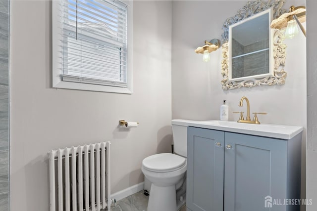 bathroom featuring vanity, toilet, and radiator heating unit