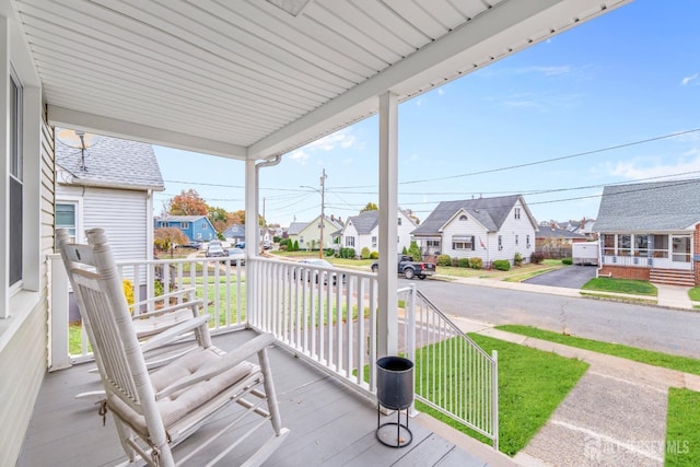 wooden terrace featuring covered porch