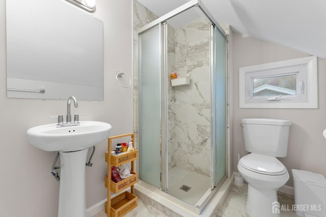 bathroom with a shower with door and toilet