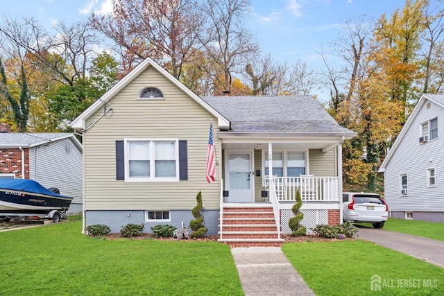 bungalow-style home featuring a front lawn and covered porch