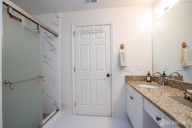 bathroom featuring visible vents, baseboards, vanity, and a shower stall