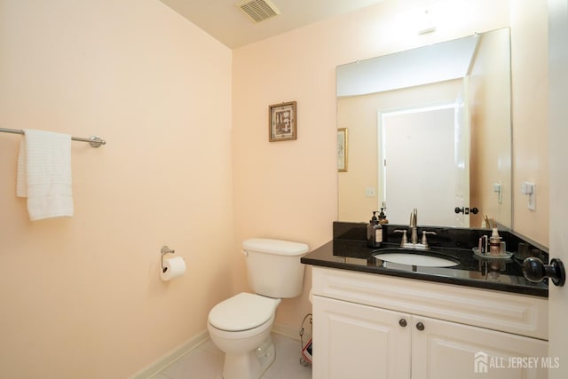 half bathroom featuring visible vents, toilet, tile patterned flooring, baseboards, and vanity