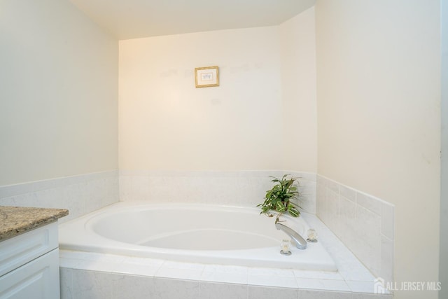 bathroom featuring vanity and a bath