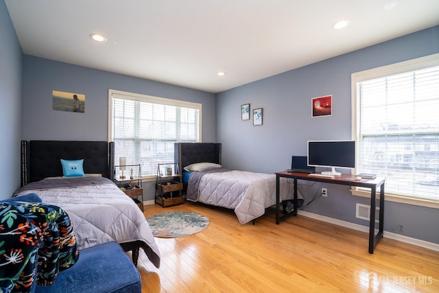 bedroom with recessed lighting, visible vents, light wood-type flooring, and baseboards