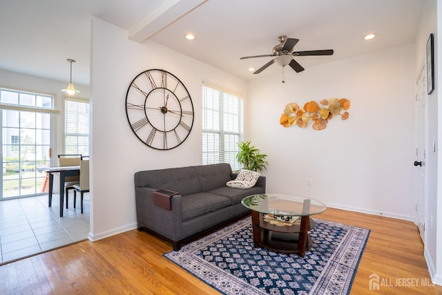 living area with light wood finished floors, recessed lighting, baseboards, and ceiling fan