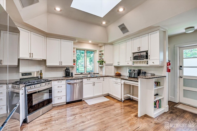 227 Lawrence Ave, Highland Park, NJ 08904 - kitchen featuring open shelves, stainless steel appliances, white cabinets, tasteful backsplash, and recessed lighting
