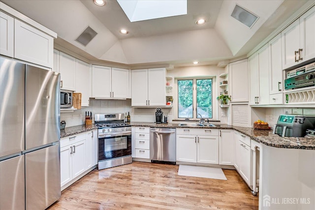 227 Lawrence Ave, Highland Park, NJ 08904 - kitchen featuring appliances with stainless steel finishes, open shelves, white cabinetry, vaulted ceiling, and recessed lighting