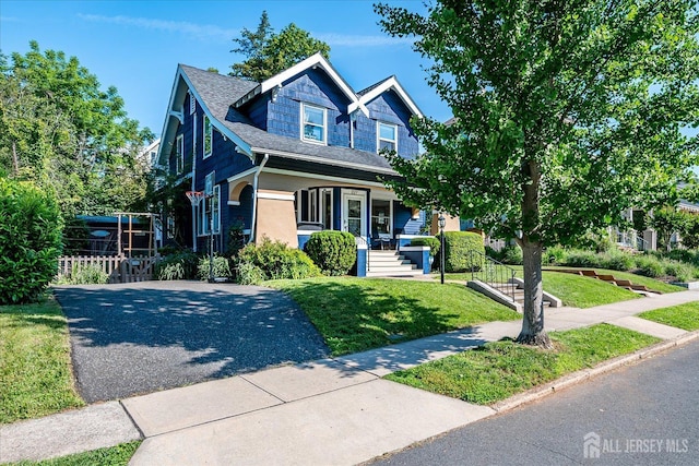 227 Lawrence Ave, Highland Park, NJ 08904 - view of front of house with a porch, a front yard, and driveway