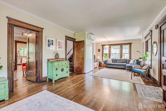 227 Lawrence Ave, Highland Park, NJ 08904 - living area with dark wood finished floors, an AC wall unit, healthy amount of natural light, and crown molding