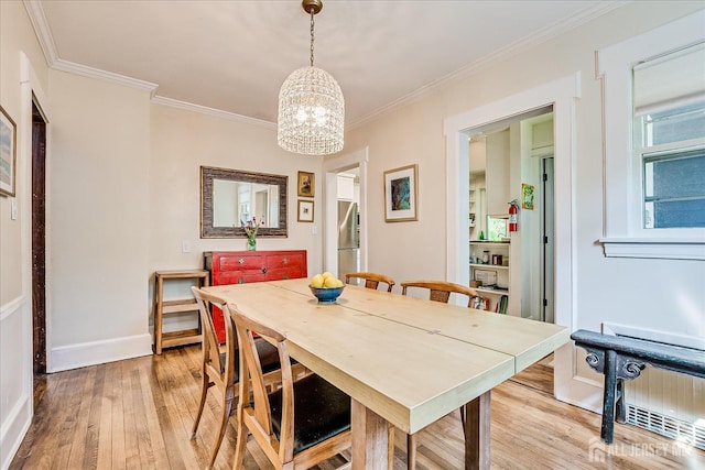 227 Lawrence Ave, Highland Park, NJ 08904 - dining room featuring a chandelier, light wood-type flooring, ornamental molding, and radiator heating unit