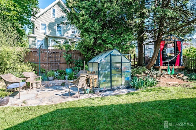 227 Lawrence Ave, Highland Park, NJ 08904 - view of yard featuring a greenhouse, an outdoor structure, and a patio
