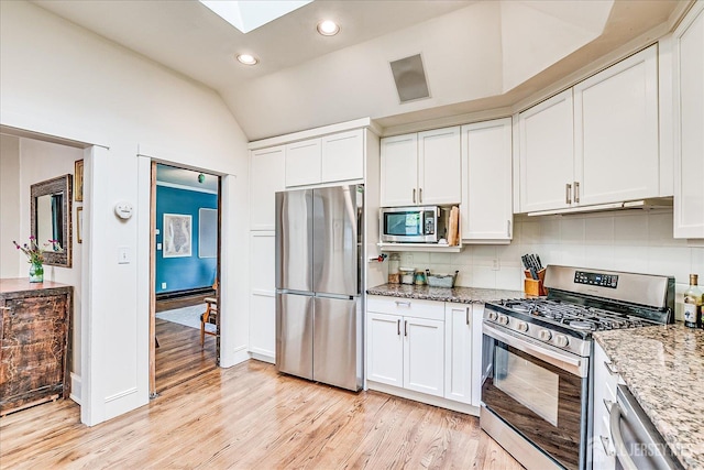227 Lawrence Ave, Highland Park, NJ 08904 - kitchen with stainless steel appliances, vaulted ceiling, light wood-type flooring, light stone counters, and recessed lighting