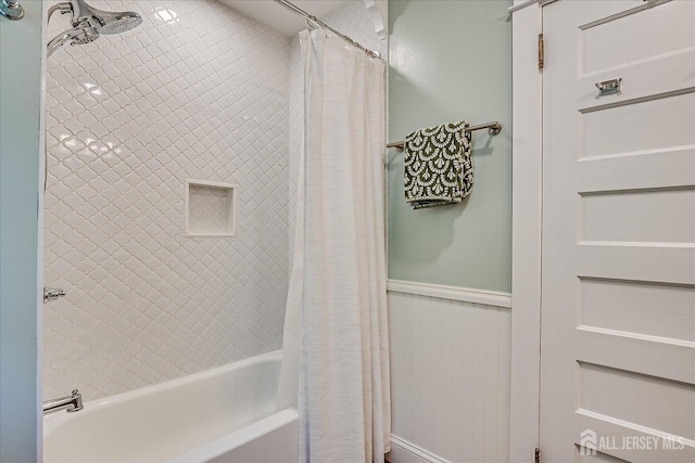 227 Lawrence Ave, Highland Park, NJ 08904 - bathroom featuring shower / bath combination with curtain and a wainscoted wall