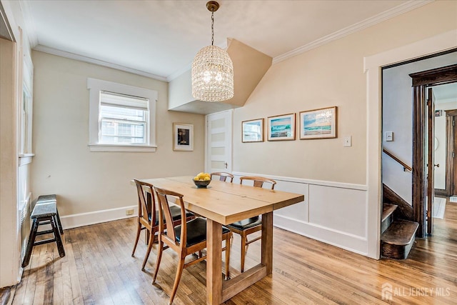 227 Lawrence Ave, Highland Park, NJ 08904 - dining room with ornamental molding, a chandelier, light wood finished floors, stairway, and wainscoting