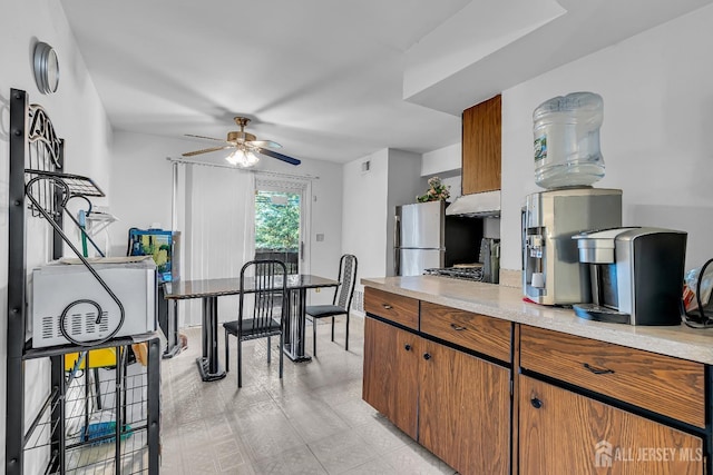 199 Evergreen Rd Unit 6A, Edison, NJ 08837 - kitchen featuring freestanding refrigerator, under cabinet range hood, ceiling fan, and brown cabinets