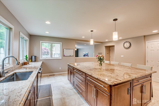 8 Renee Ct, Edison, NJ 08820 - kitchen with a sink, brown cabinets, recessed lighting, baseboards, and light stone counters