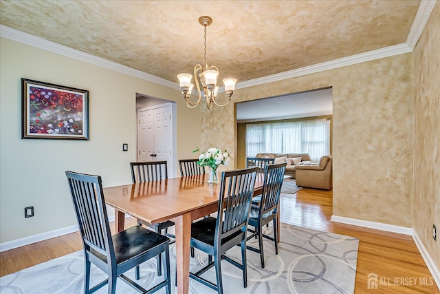 8 Renee Ct, Edison, NJ 08820 - dining area with light wood-style flooring, a chandelier, baseboards, and crown molding
