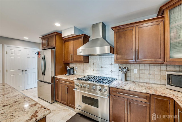 8 Renee Ct, Edison, NJ 08820 - kitchen featuring stainless steel appliances, wall chimney range hood, light stone counters, backsplash, and recessed lighting