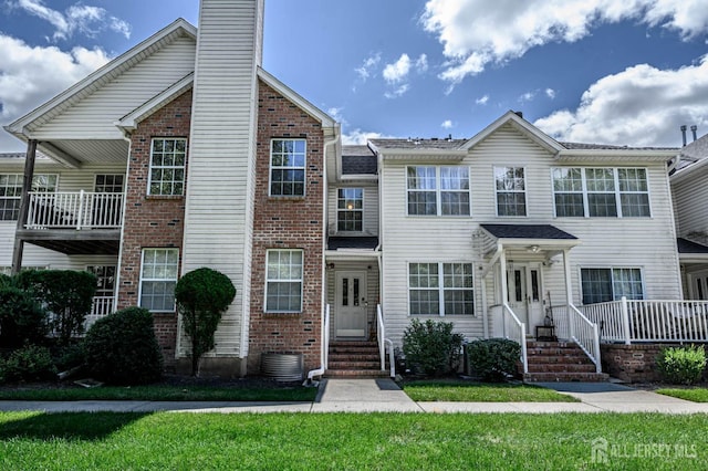 219 Vasser Dr, Piscataway, NJ 08854 - view of property with brick siding, a chimney, central air condition unit, a front yard, and entry steps