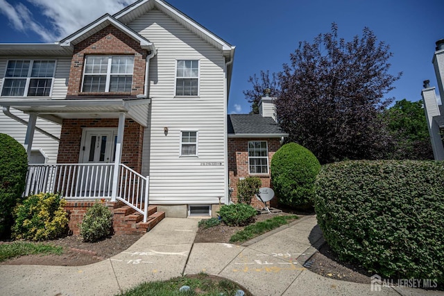 219 Vasser Dr, Piscataway, NJ 08854 - view of front of house with brick siding and a chimney