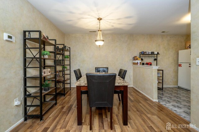 219 Vasser Dr, Piscataway, NJ 08854 - dining room featuring wood finished floors and baseboards