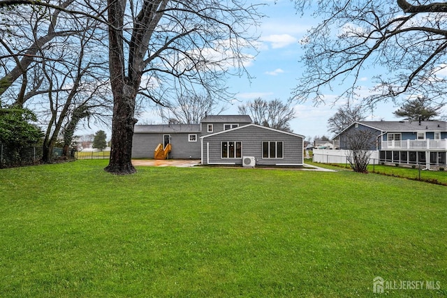 back of house featuring a yard and fence