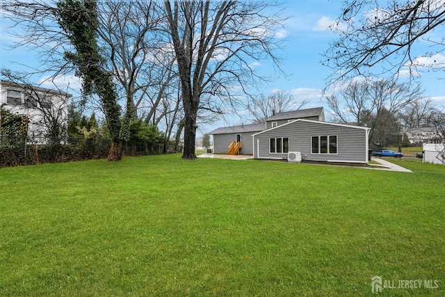 exterior space featuring a lawn and fence