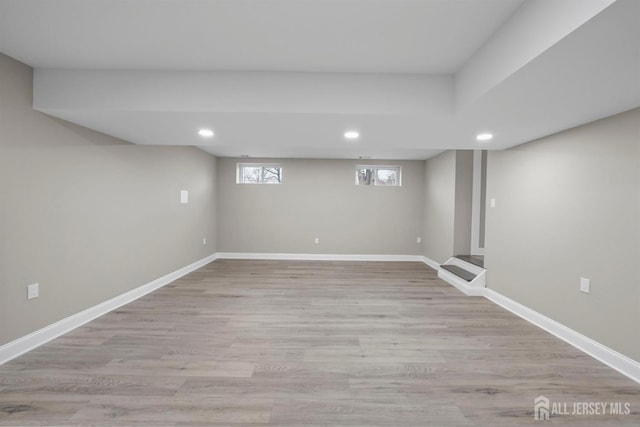 basement with light wood-style flooring, baseboards, and recessed lighting