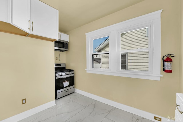 kitchen featuring appliances with stainless steel finishes and white cabinetry