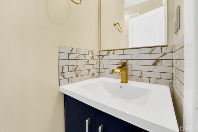 bathroom featuring vanity and decorative backsplash