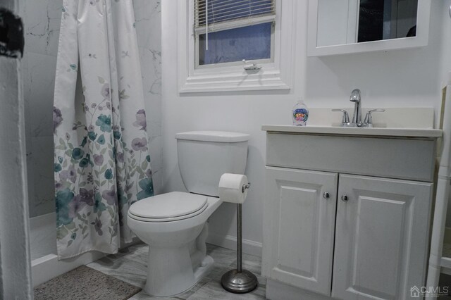 bathroom featuring vanity, toilet, and walk in shower