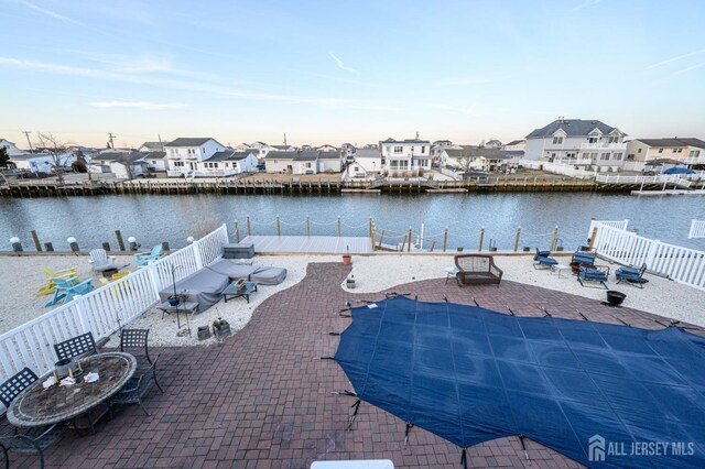 111 E Shrewsbury Dr E, Little Egg Harbor, NJ 08087 - fenced backyard featuring a patio area, a water view, a residential view, and a fire pit
