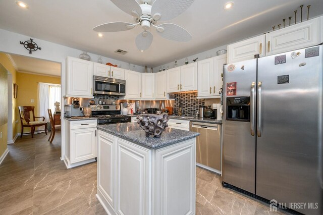 111 E Shrewsbury Dr E, Little Egg Harbor, NJ 08087 - kitchen featuring stainless steel appliances, a kitchen island, ceiling fan, white cabinetry, and tasteful backsplash