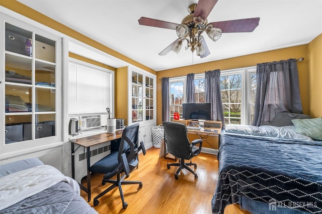 286 Easton Ave, New Brunswick, NJ 08901 - bedroom with radiator, cooling unit, light wood finished floors, and an office area